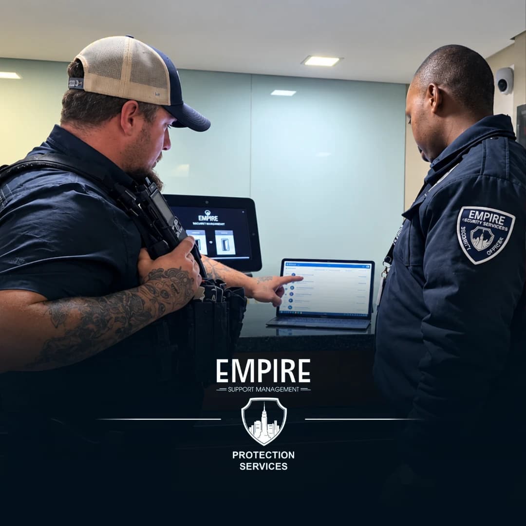 Two Empire officers reviewing the EMR reporting system on a laptop at a building reception desk