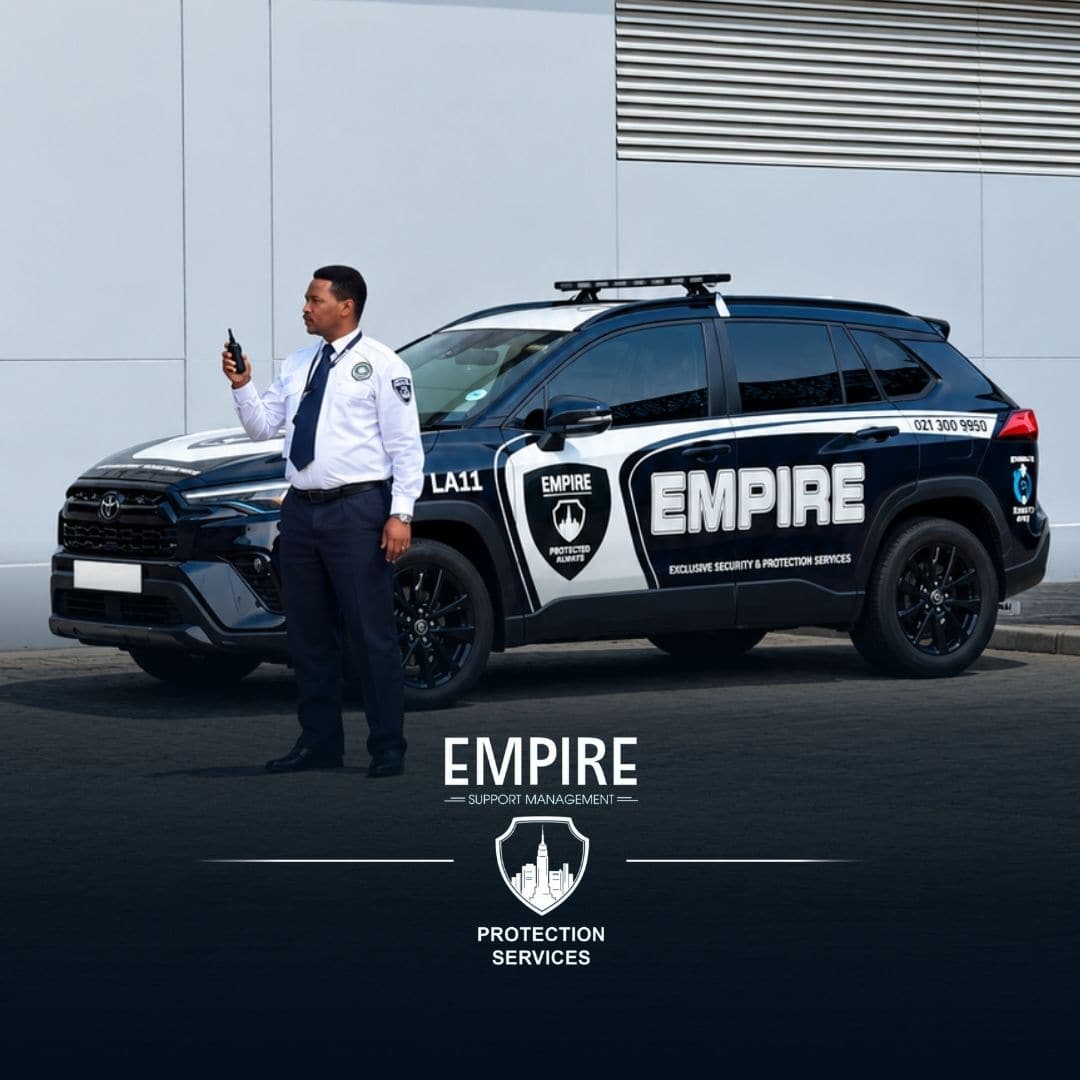 Empire officer with a radio standing beside a branded Empire patrol vehicle