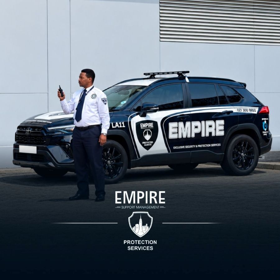 Empire officer with a radio standing beside a branded Empire patrol vehicle
