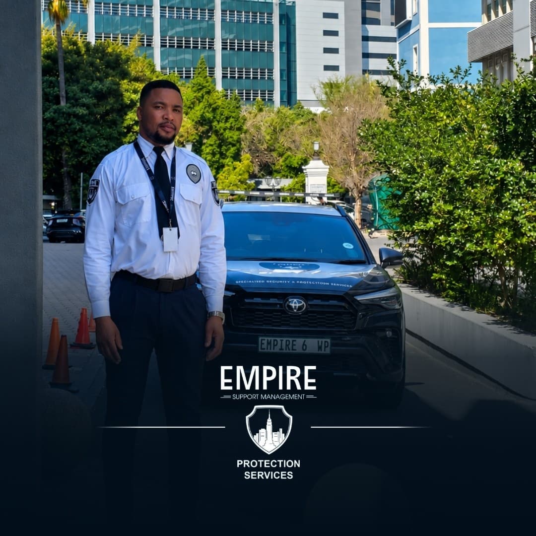 Empire officer standing at a site entrance in front of an Empire vehicle